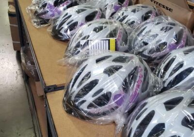 Assorted cycle helmets displayed at a Bicycle Shop Los Angeles for rider safety